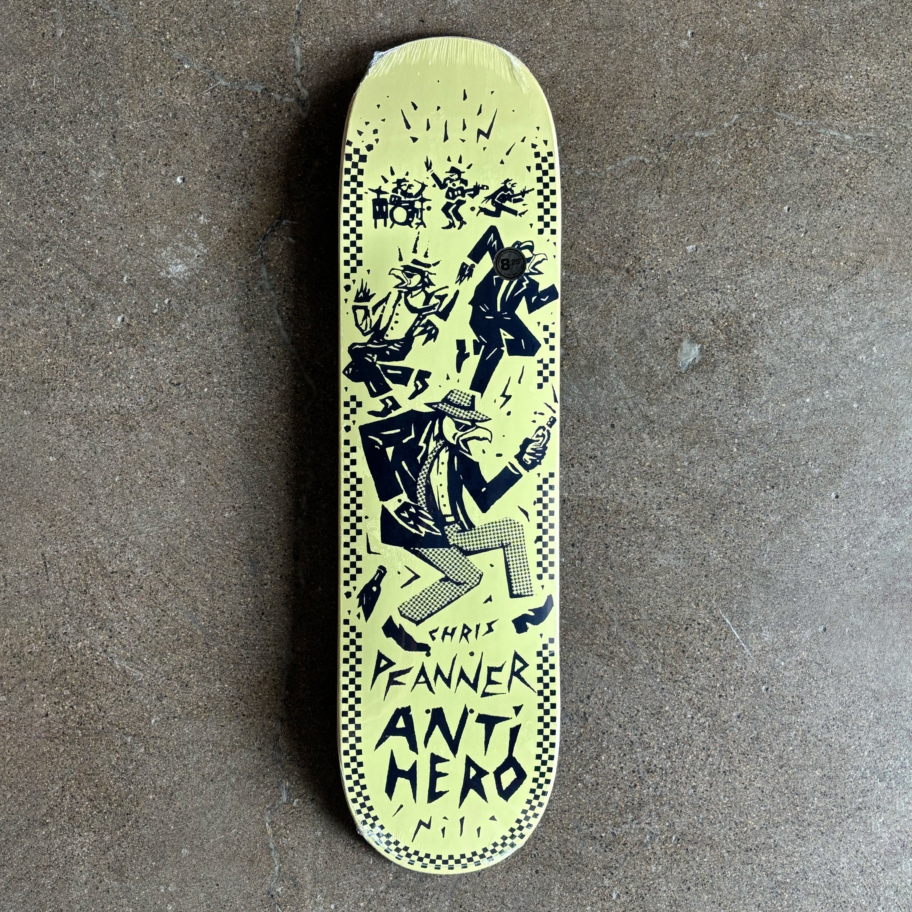 Skateboard deck with black graphics and 'Anti Hero' text on a gray surface